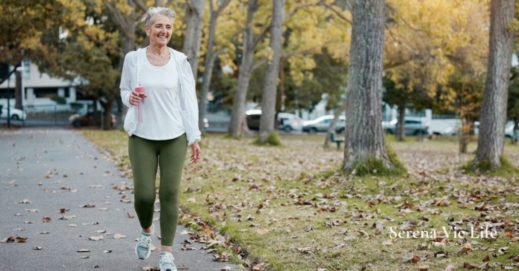 woman over 50 walking in park as part of daily movement habit