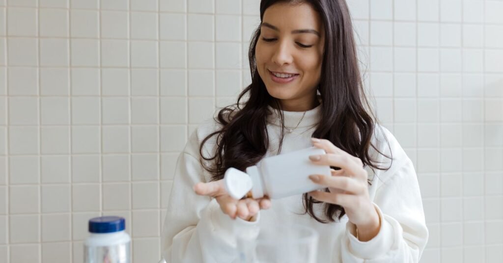 Woman checking a magnesium supplement bottle, comparing magnesium glycinate and citrate for menopause